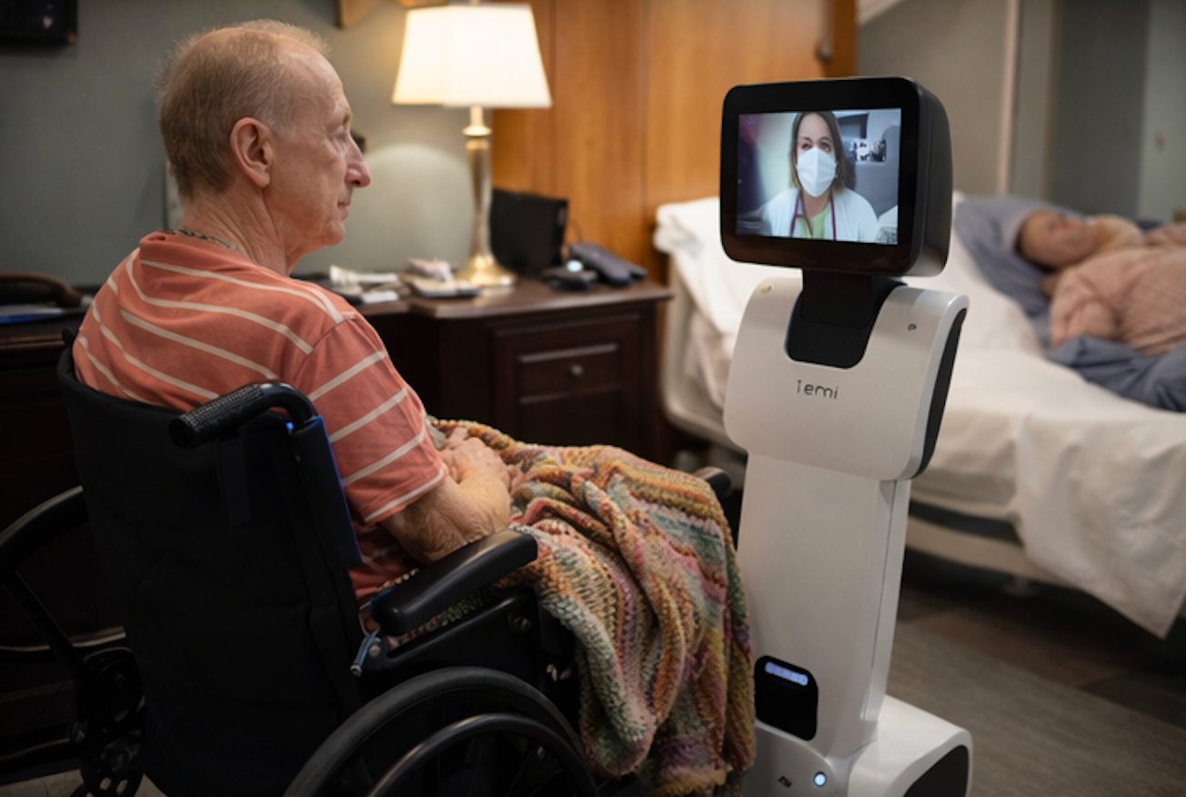 Patient in wheelchair consulting physician via bedside robot