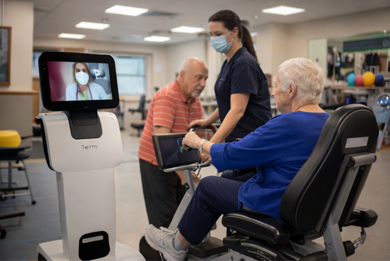 Telepresence robot in rehabilitation gym with patients and therapist