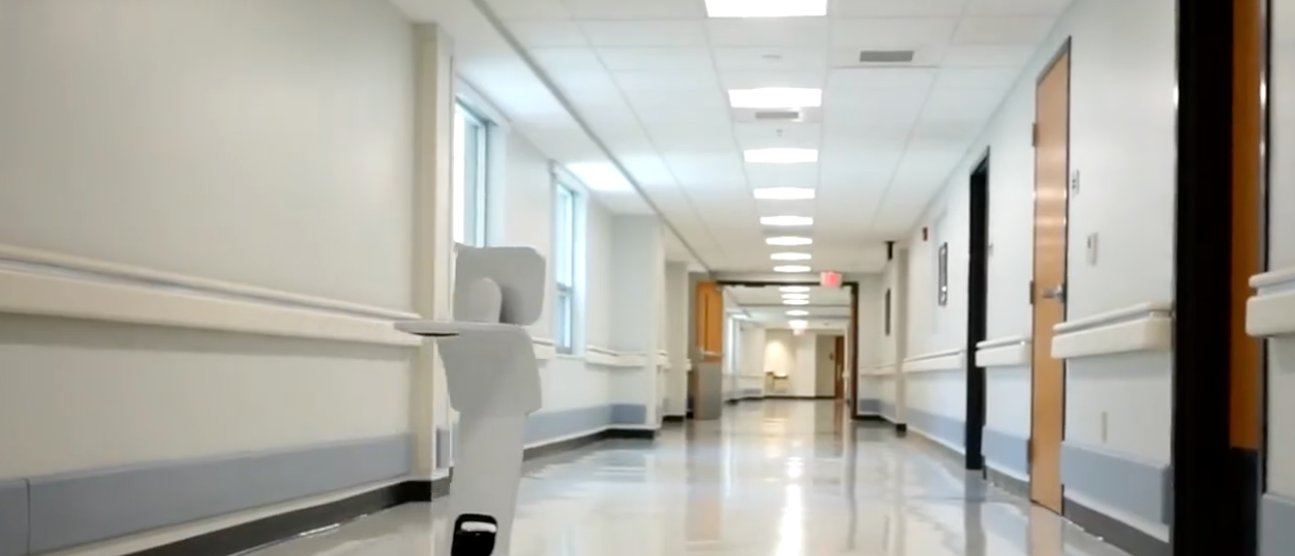 Telepresence robot in a bright facility corridor